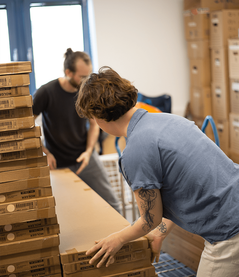 Eine Frau und ein Mann stapeln Kartons mit Möbeln